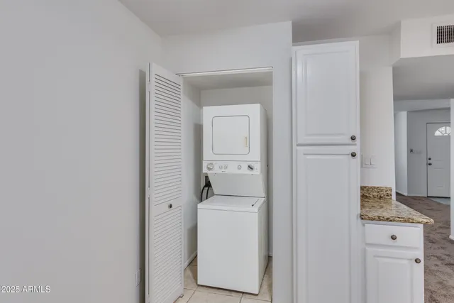 a hallway with a washer and dryer