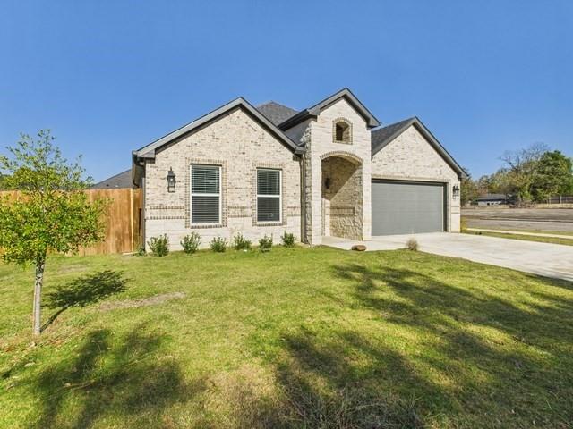 511 Richardson Street Athens, TX 75751 - Photo 2 of 40 French provincial home with concrete driveway, brick siding, and an attached garage