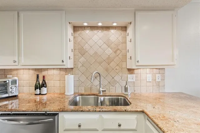 a view of staircase with white walls and a mirror