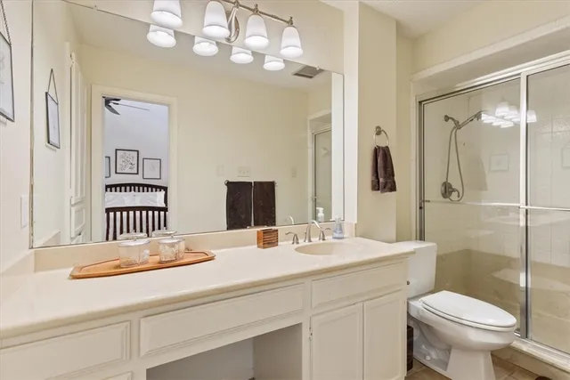 a bedroom with a bed and a table with lamp