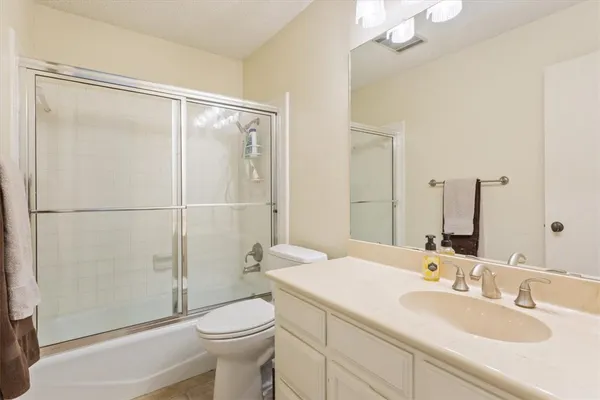 a bedroom with a bed and a book shelf