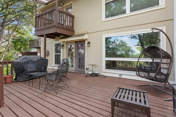 a view of balcony with wooden floor and seating space