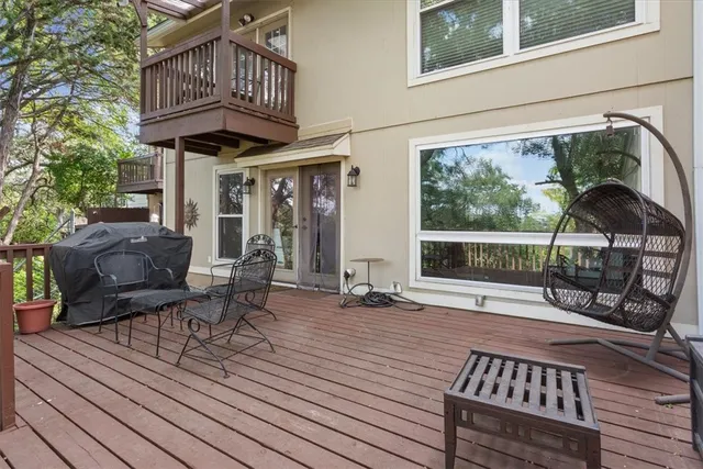 a view of balcony with wooden floor and seating space