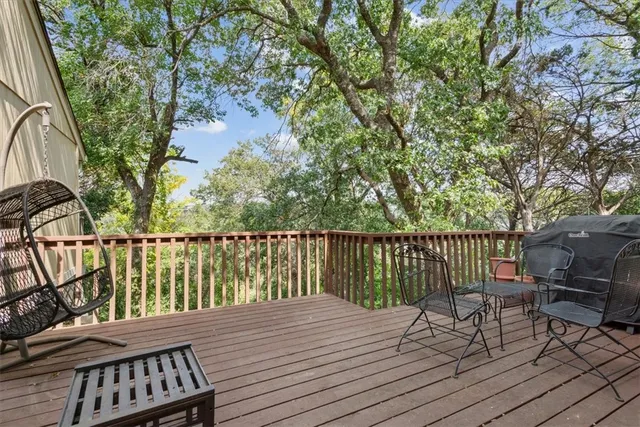 a view of balcony with wooden floor and outdoor seating