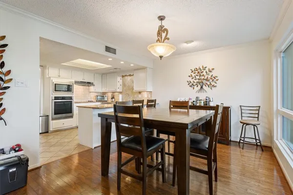 a kitchen with a sink a counter top space appliances and cabinets