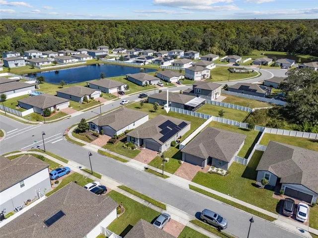 an aerial view of residential houses with outdoor space