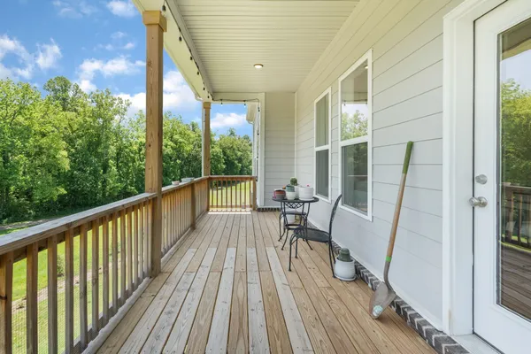 a view of balcony with wooden floor and outdoor seating