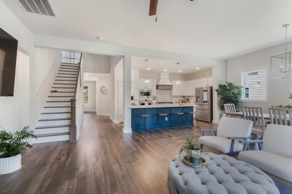a living room with furniture and wooden floor