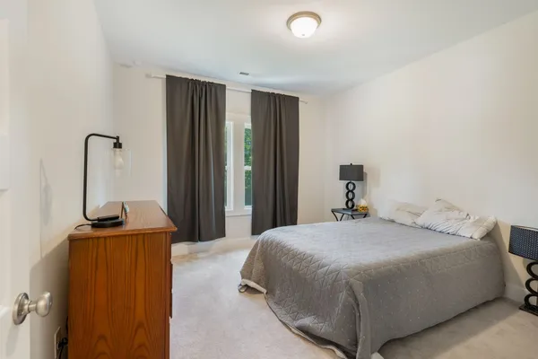 a bedroom with a bed and a mirror