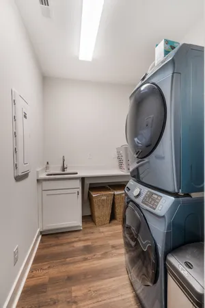 a utility room with sink dryer and washer
