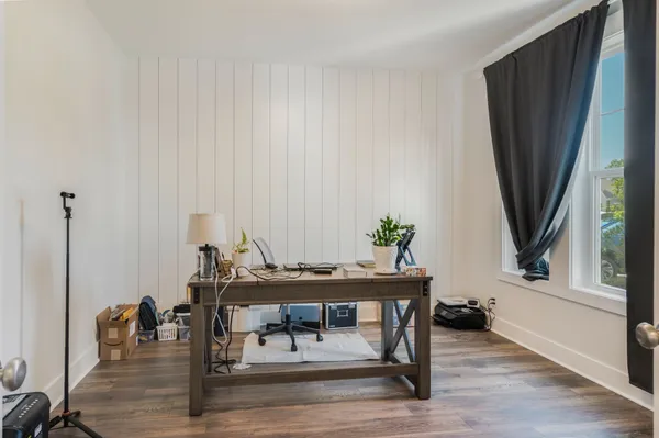 a dining room with furniture and wooden floor