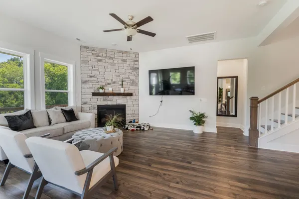 a living room with furniture wooden floor and a fireplace