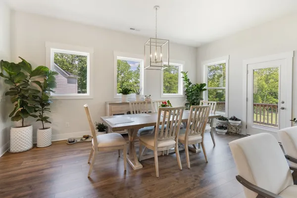 a view of a dining room with furniture window and wooden floor