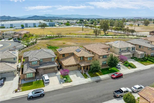 an aerial view of a house with a swimming pool and outdoor space