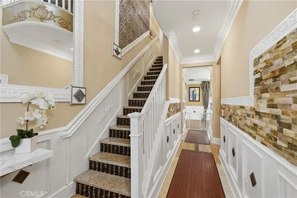 a kitchen with stainless steel appliances kitchen island granite countertop a table chairs and a refrigerator