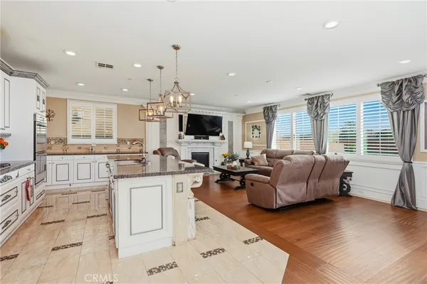 a kitchen with stainless steel appliances granite countertop a sink stove and microwave