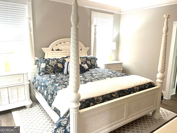 a bed sitting in a bedroom next to a window