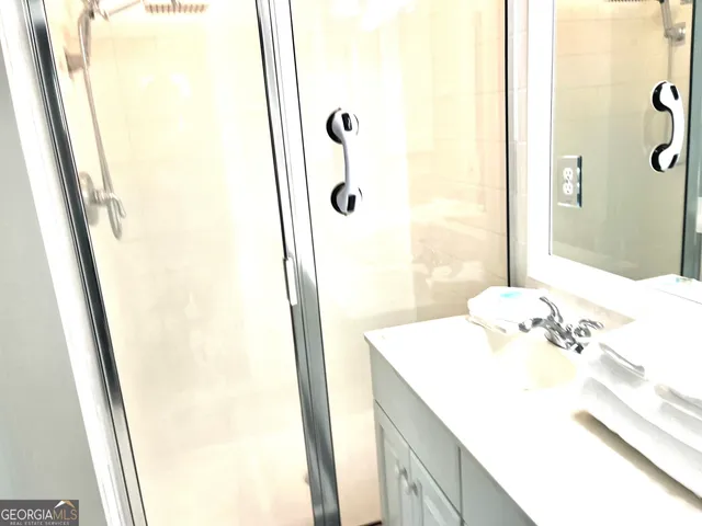 a bathroom with a sink a mirror and shower