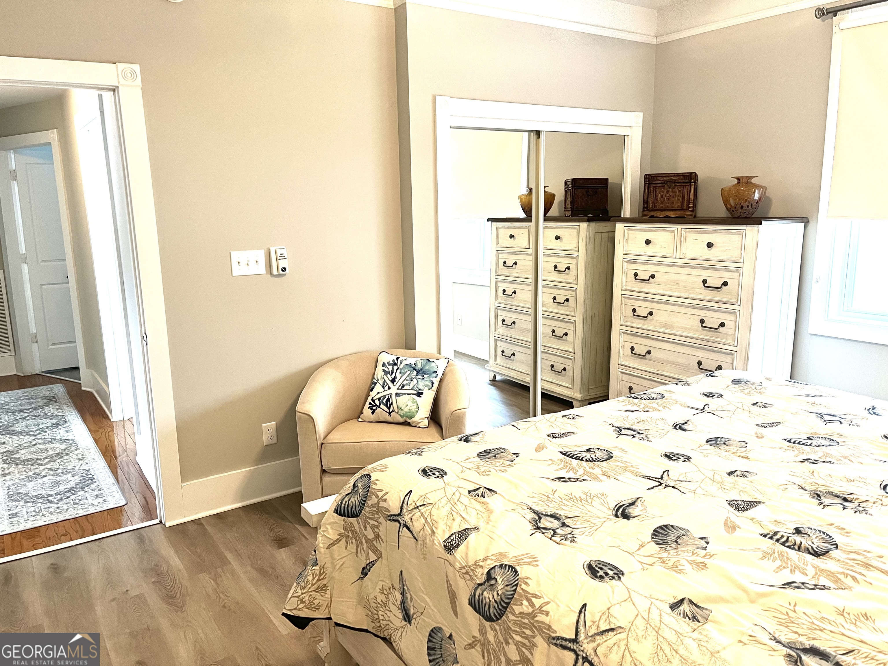 122 Shady Brook Circle, Unit 100 St. Simons, GA 31522 - Photo 23 of 39 a bedroom with a bed and a dresser