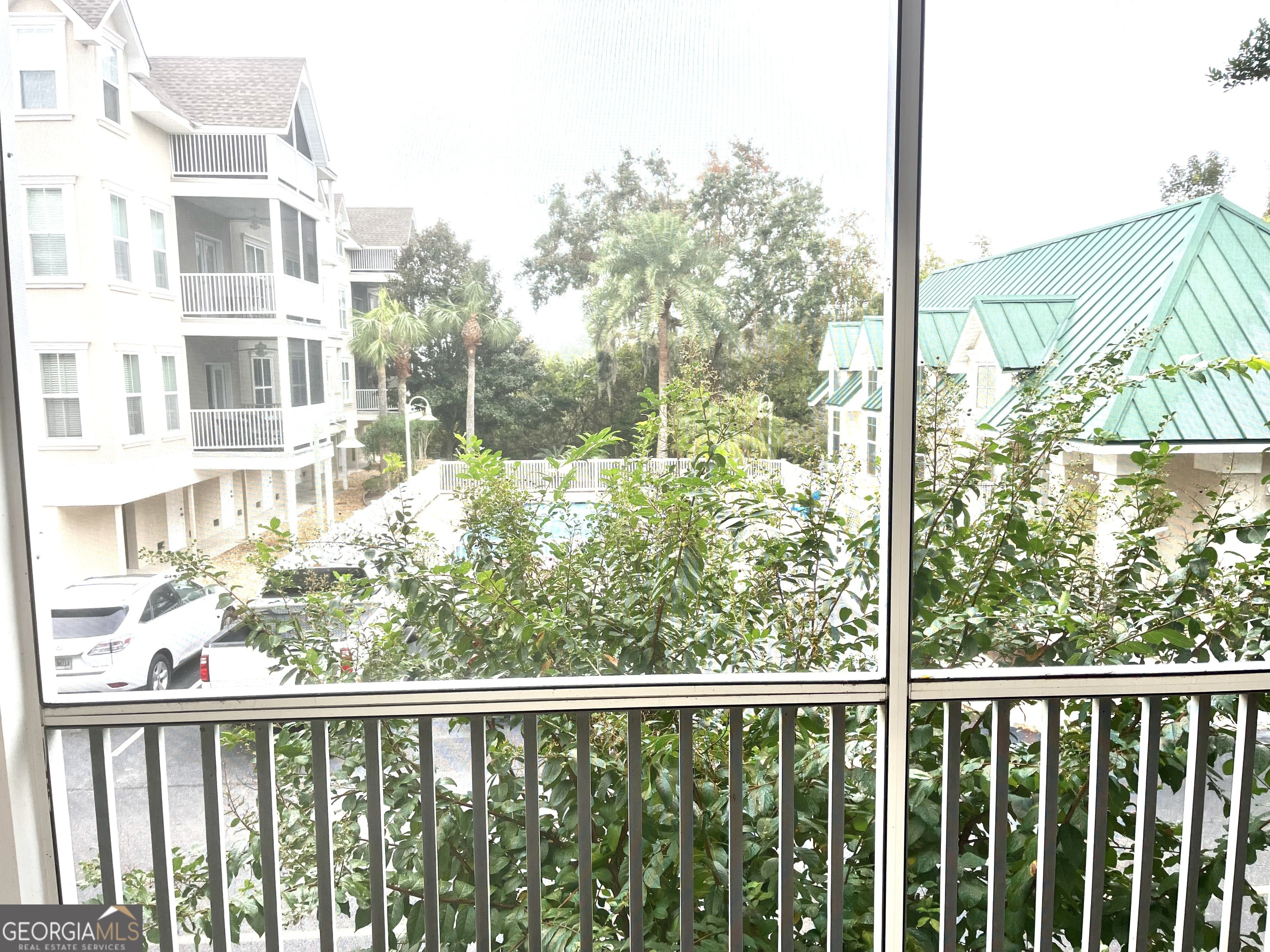 122 Shady Brook Circle, Unit 100 St. Simons, GA 31522 - Photo 30 of 39 a view of a building from a window