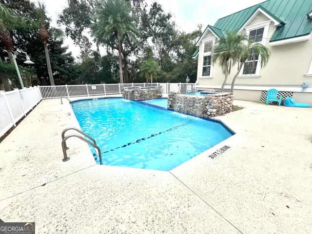 a view of a swimming pool with a patio