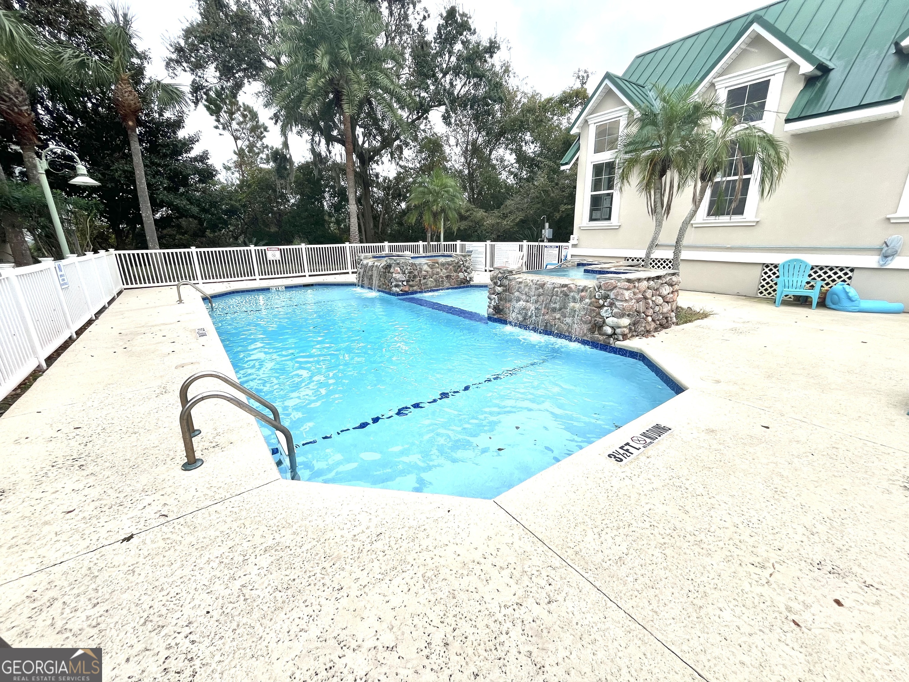 122 Shady Brook Circle, Unit 100 St. Simons, GA 31522 - Photo 32 of 39 a view of a swimming pool with a patio