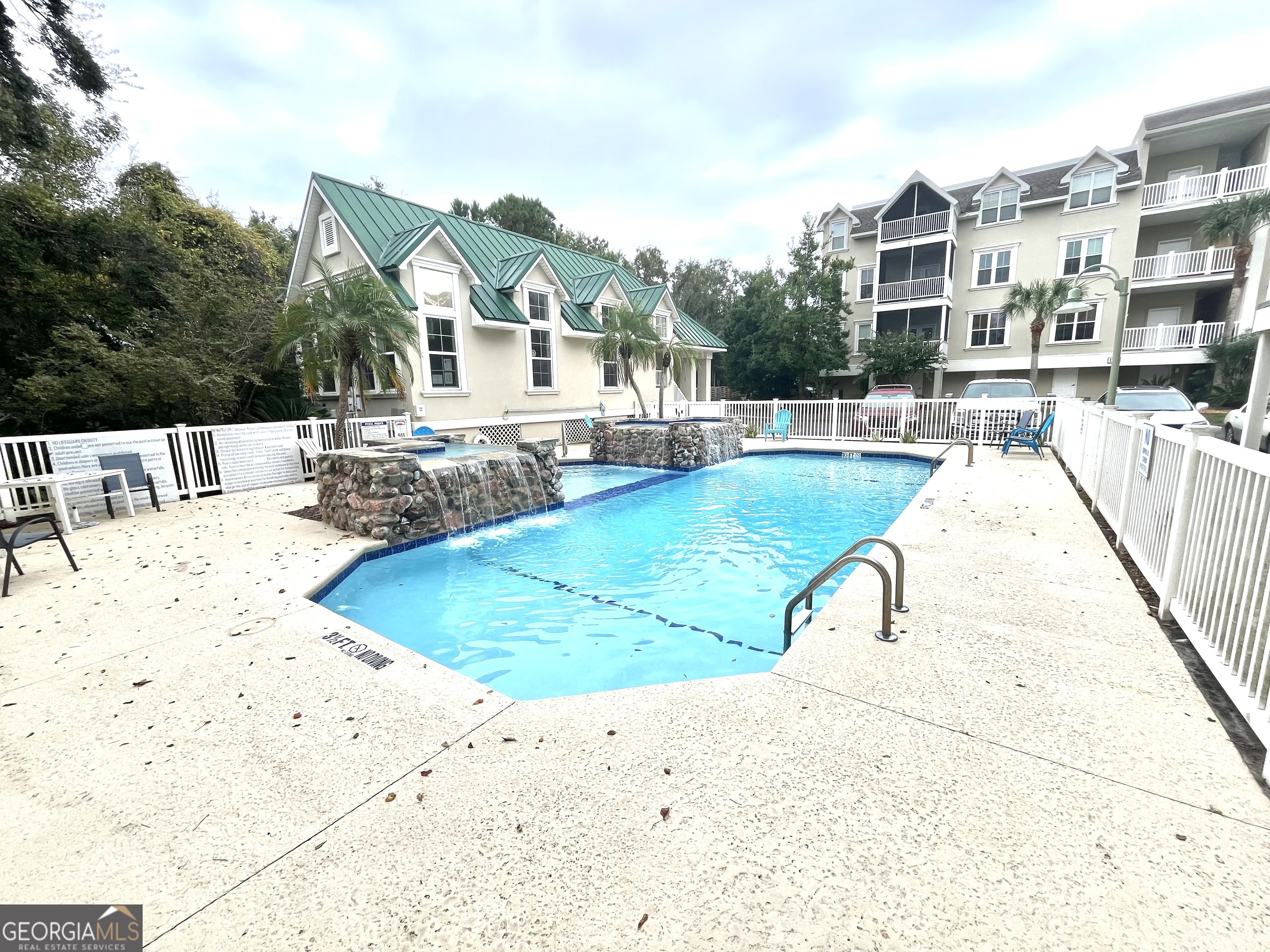 122 Shady Brook Circle, Unit 100 St. Simons, GA 31522 - Photo 33 of 39 a view of a swimming pool with a patio