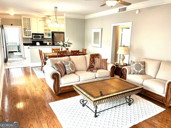 a living room with furniture a rug and a table
