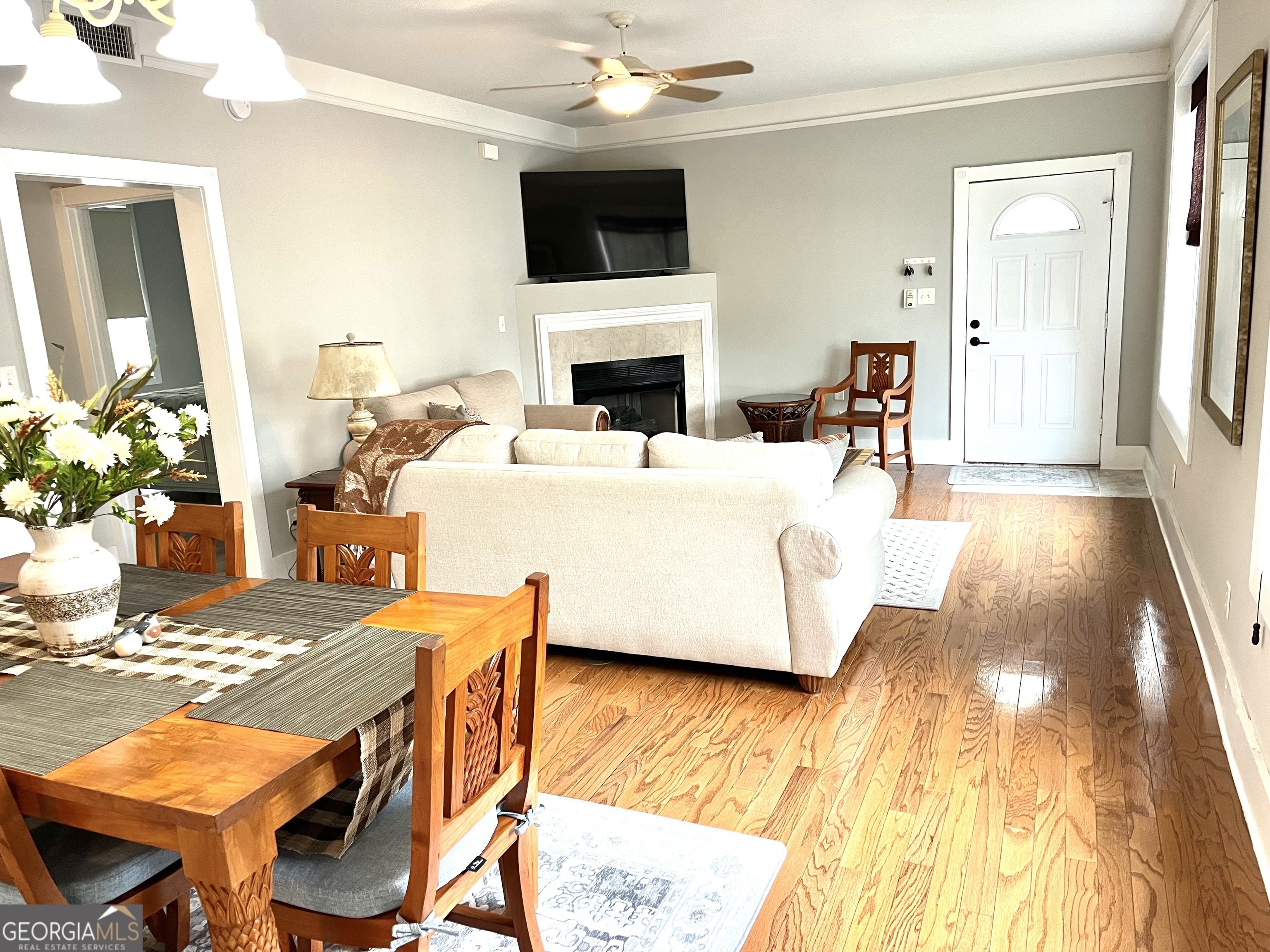 122 Shady Brook Circle, Unit 100 St. Simons, GA 31522 - Photo 8 of 39 a living room with furniture and a flat screen tv