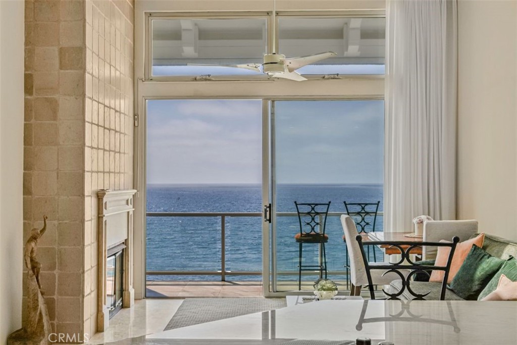 615 Esplanade, Unit 407 Redondo Beach, CA 90277 - Photo 18 of 45 a dining room with glass top table and chairs
