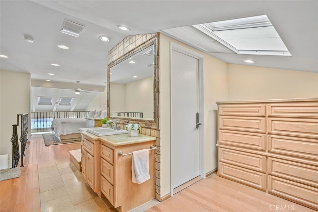 615 Esplanade, Unit 407 Redondo Beach, CA 90277 - Photo 20 of 45 a view of a kitchen with kitchen island stainless steel appliances wooden floor and window