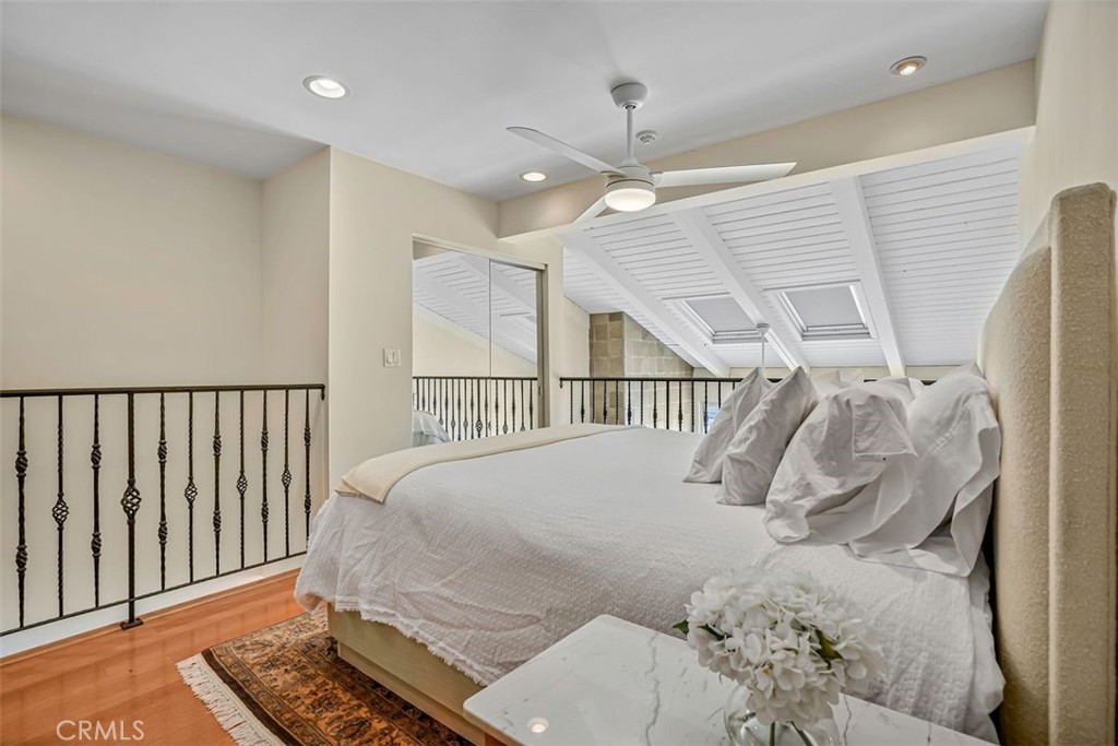 615 Esplanade, Unit 407 Redondo Beach, CA 90277 - Photo 23 of 45 a bedroom with a large bed and a chandelier