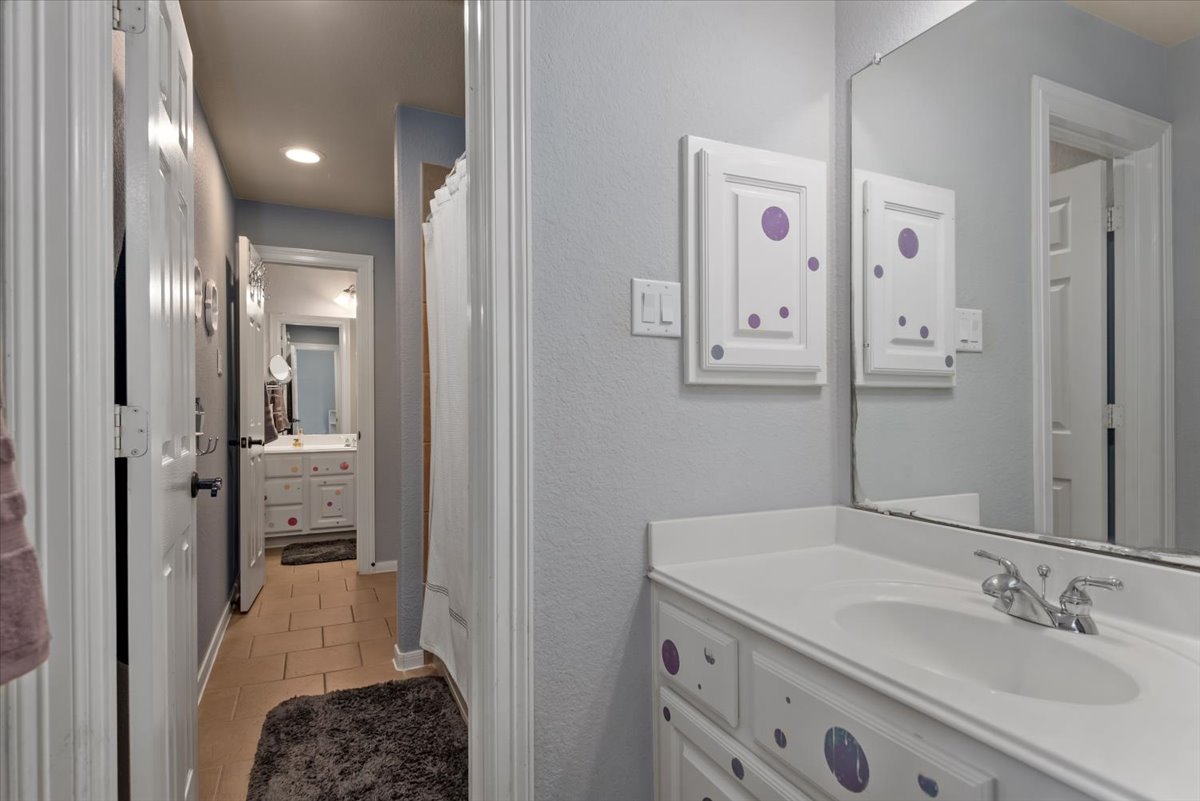 15519 Stallion Point Circle Cypress, TX 77429 - Photo 25 of 37 Bathroom vanity with an integrated sink and mirror