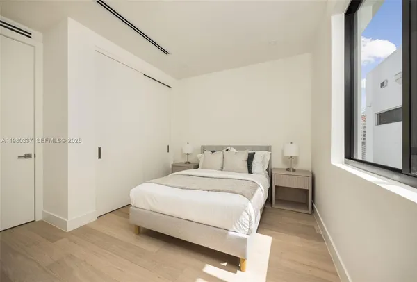 a bedroom with a bed and a window