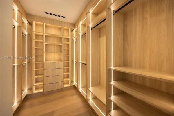 a view of walk in closet with empty racks