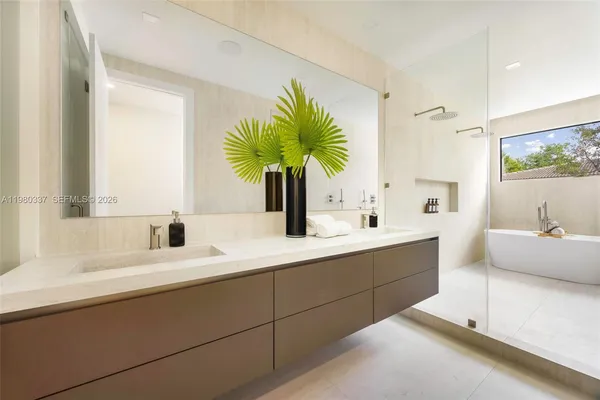 a bathroom with a double vanity sink window and flower