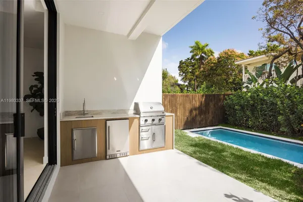 a kitchen with a refrigerator and a stove