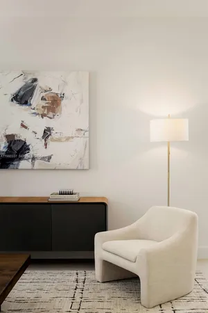 a living room with furniture and a lamp