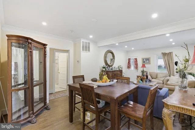 a view of a dining room and livingroom with furniture window and wooden floor