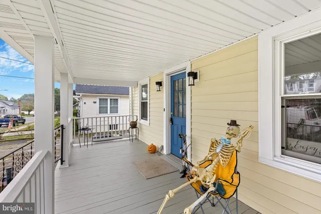 a view of a patio with table and chairs with wooden floor and fence