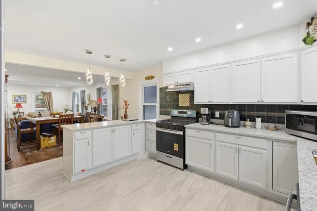a kitchen with a sink stove and cabinets