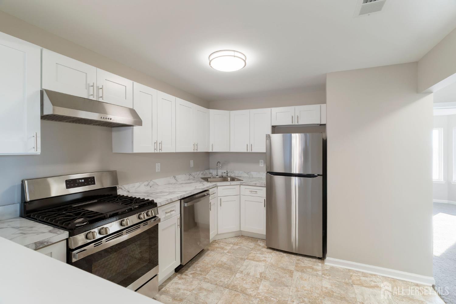 104 Jesse Way Piscataway, NJ 08854 - Photo 12 of 26 a kitchen with a stove a refrigerator and a sink