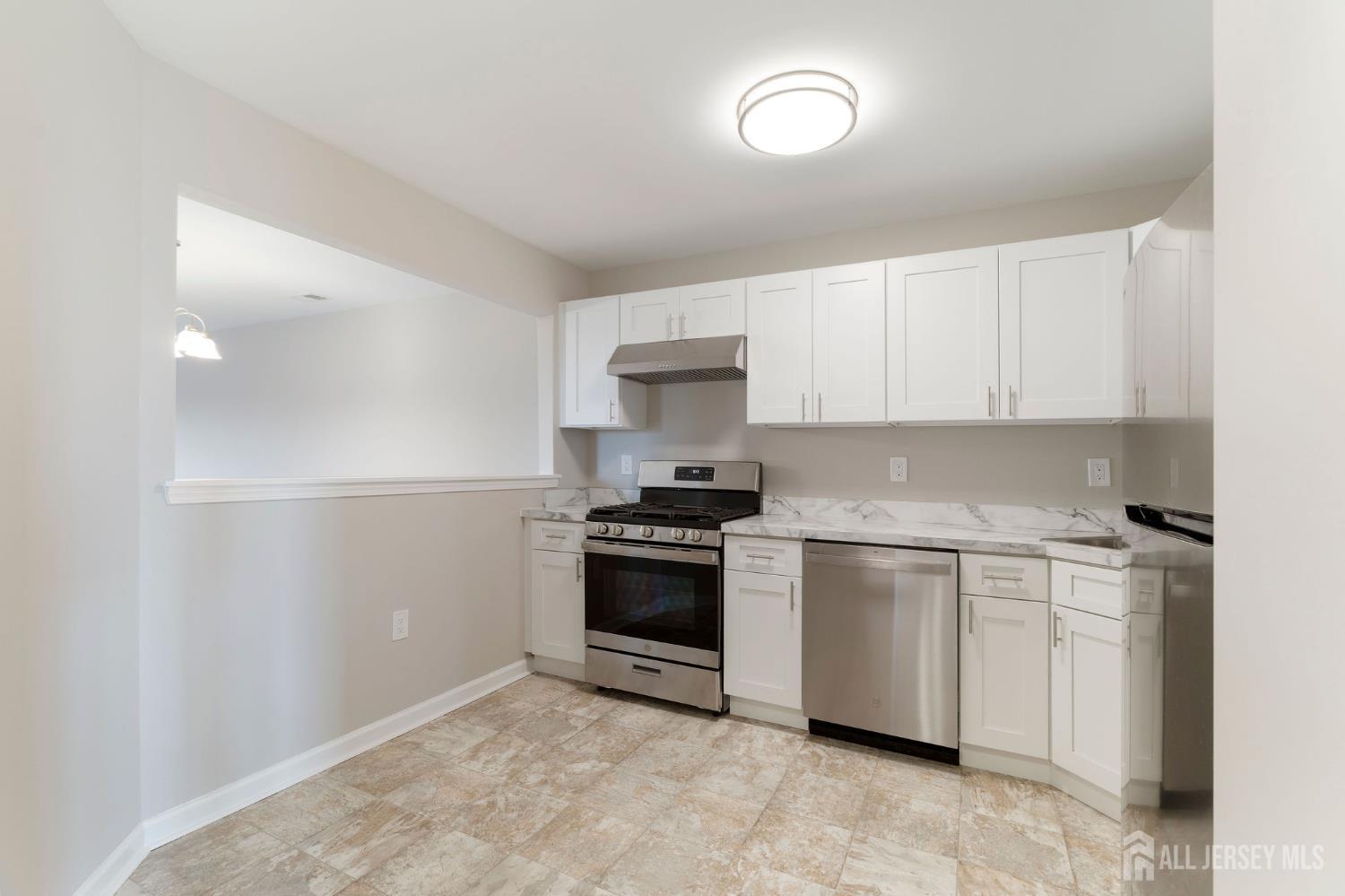104 Jesse Way Piscataway, NJ 08854 - Photo 13 of 26 a kitchen with granite countertop a sink stainless steel appliances and cabinets