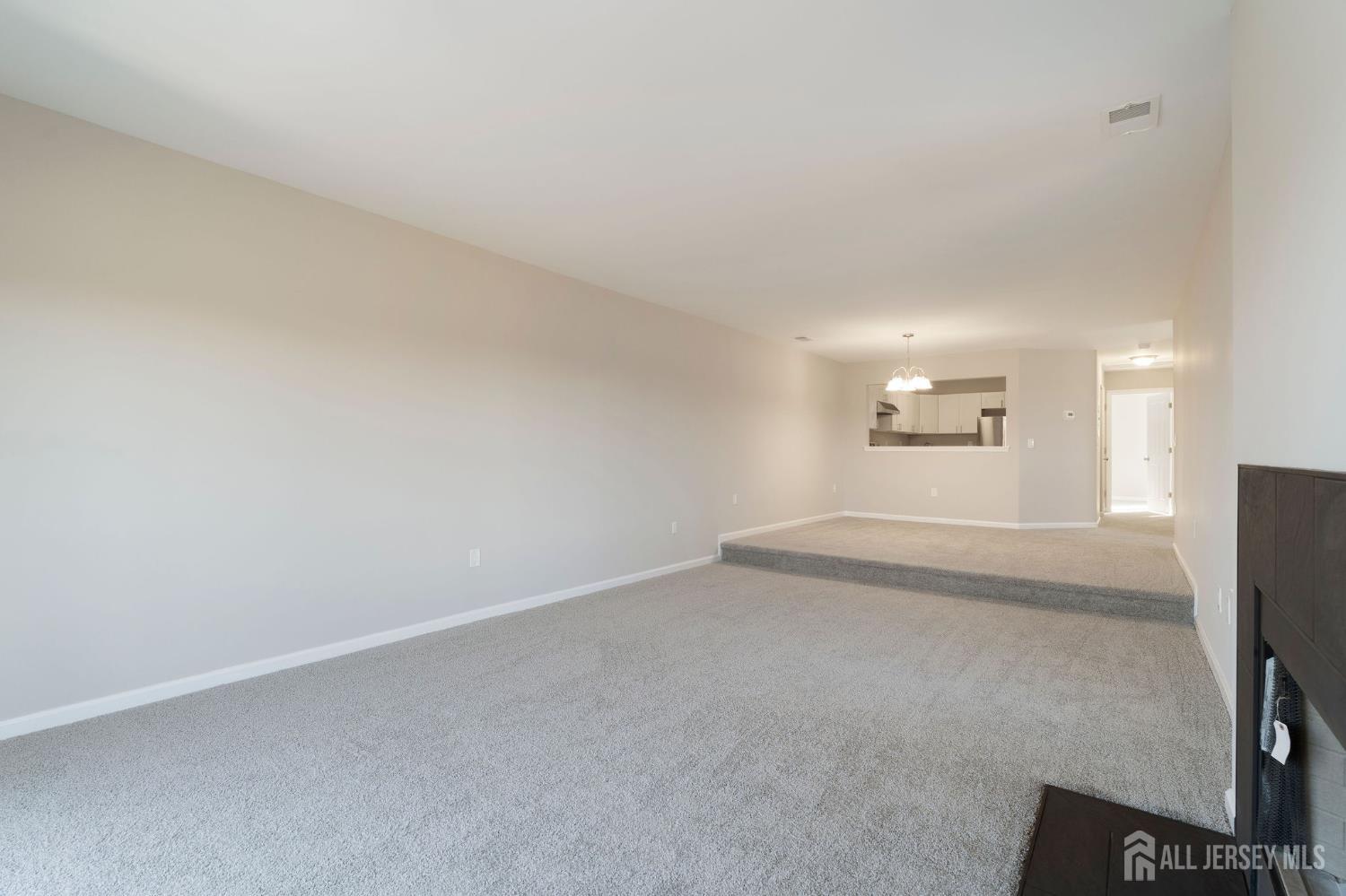 104 Jesse Way Piscataway, NJ 08854 - Photo 9 of 26 an empty room with windows and refrigerator