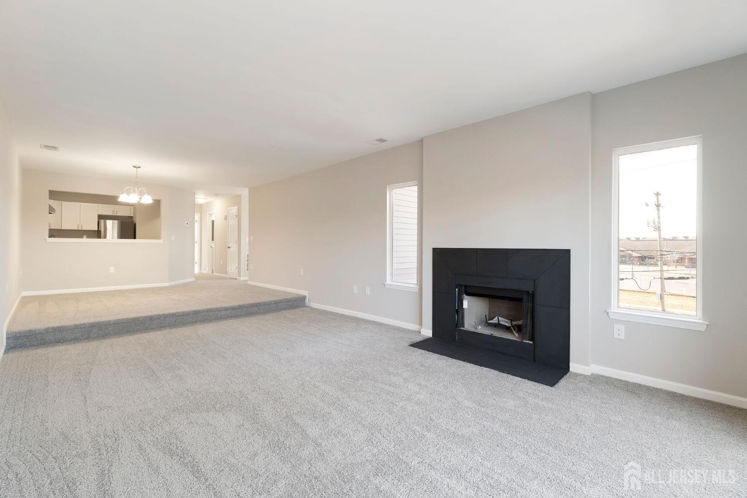104 Jesse Way Piscataway, NJ 08854 - Photo 10 of 26 an empty room with a fireplace and windows