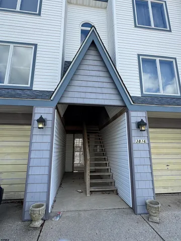 a front view of a house with stairs