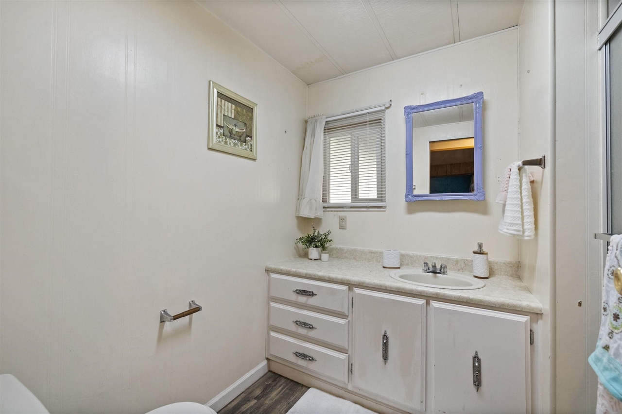 10956 Green Street, Unit 122 Columbia, CA 95310 - Photo 16 of 22 Bathroom featuring vanity and wood-type flooring