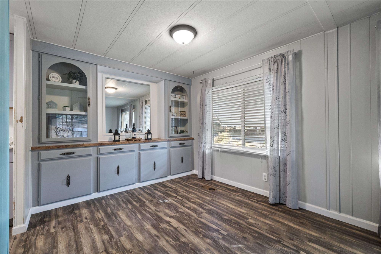 10956 Green Street, Unit 122 Columbia, CA 95310 - Photo 5 of 22 Bar with a textured ceiling and dark hardwood / wood-style flooring