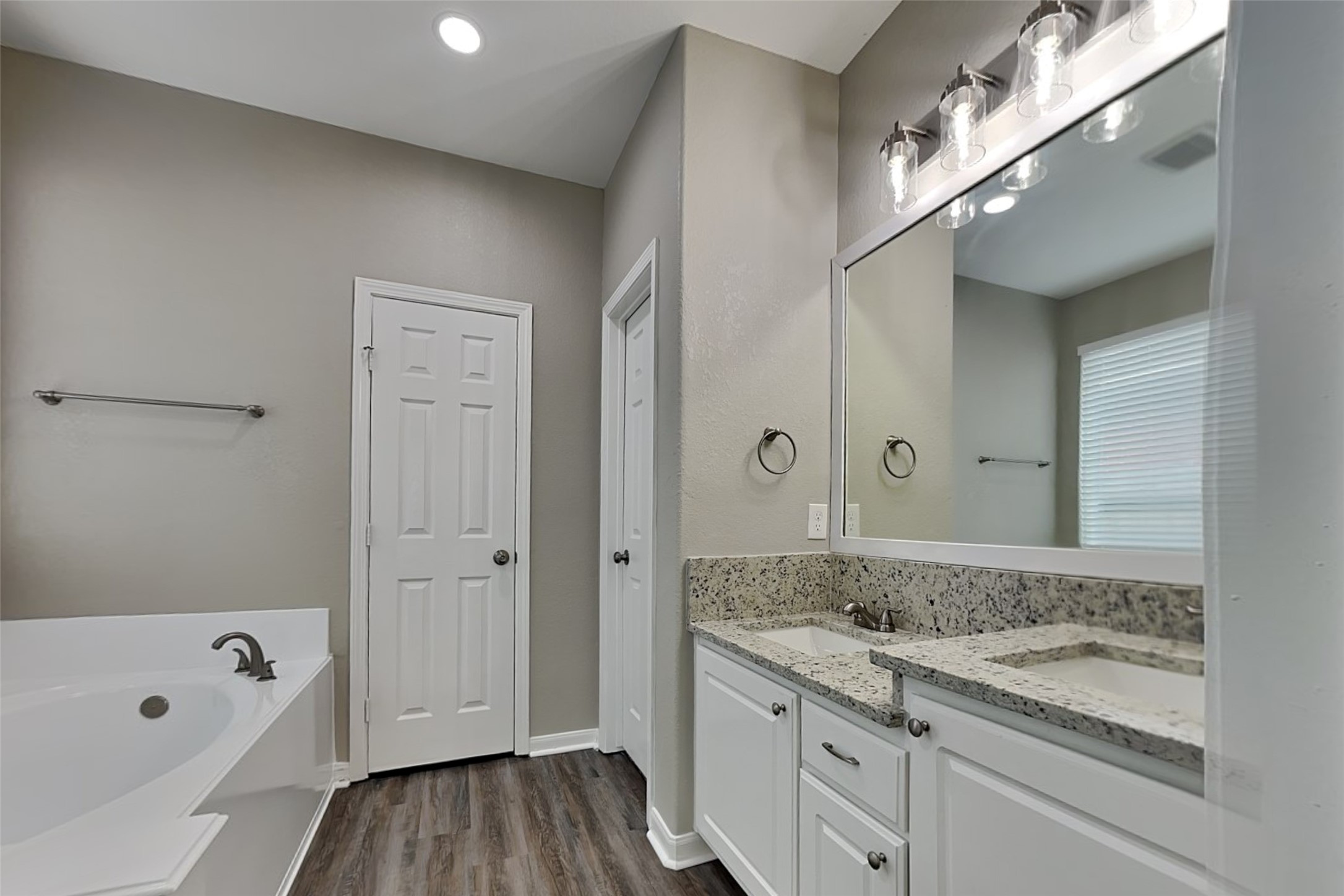 9435 Edgeloch Drive Spring, TX 77379 - Photo 11 of 18 a bathroom with a granite countertop sink a mirror a bathtub and shower