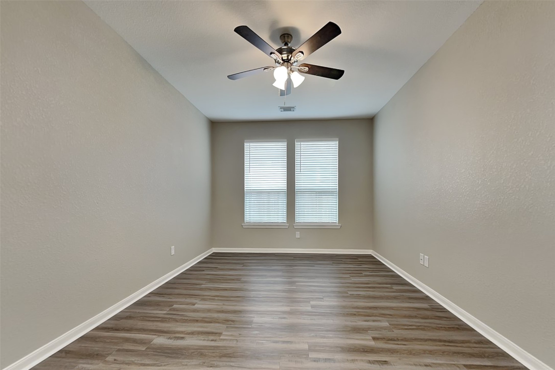 9435 Edgeloch Drive Spring, TX 77379 - Photo 15 of 18 a view of an empty room with wooden floor and a window